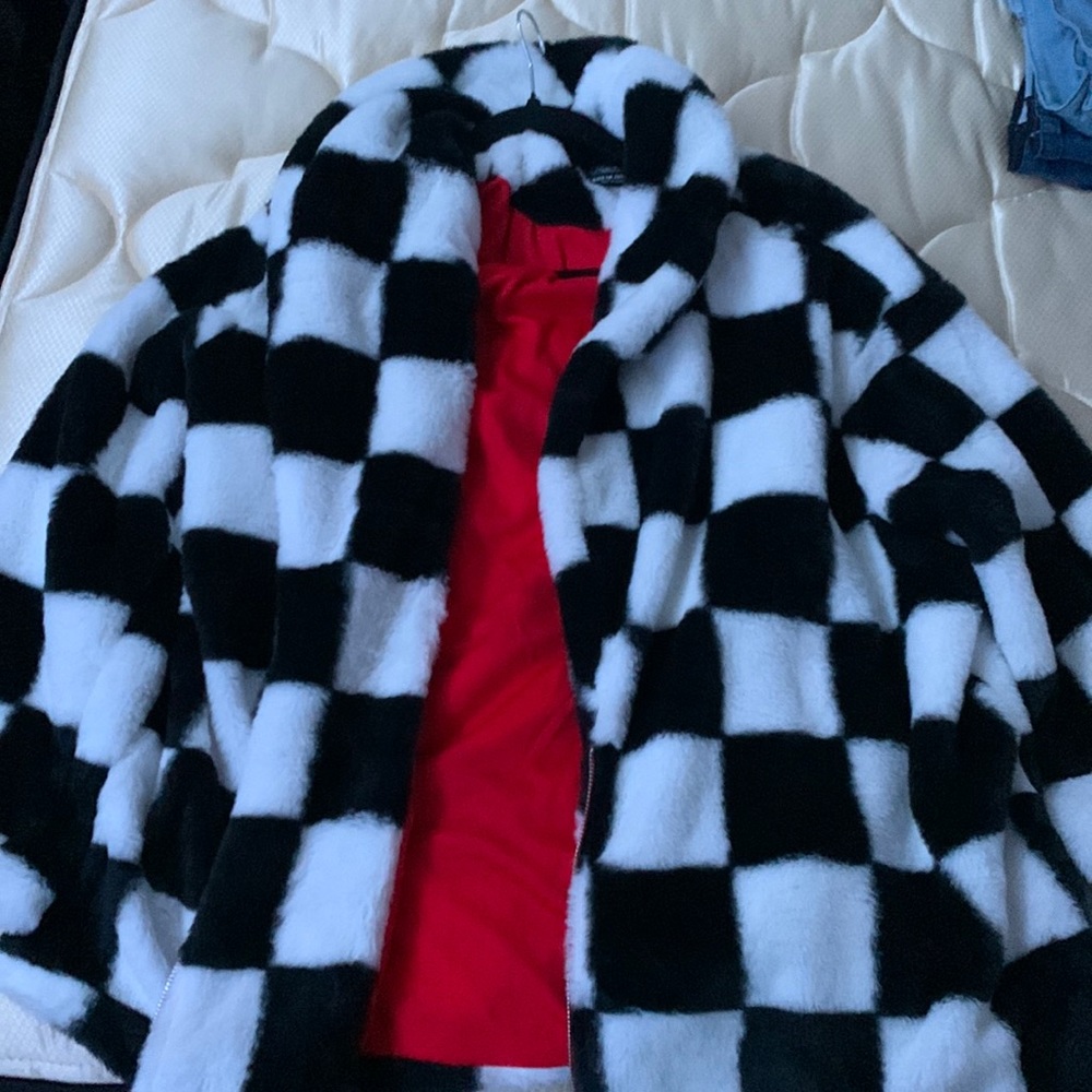 Black and white fluffy jacket with red interior